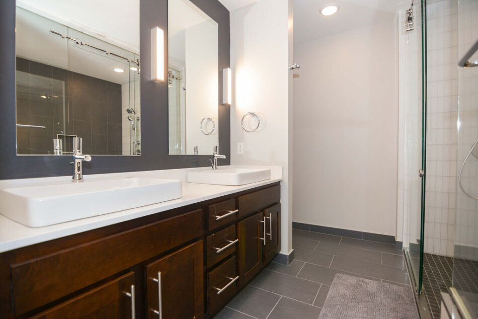 Bathroom with double sinks in long counter.