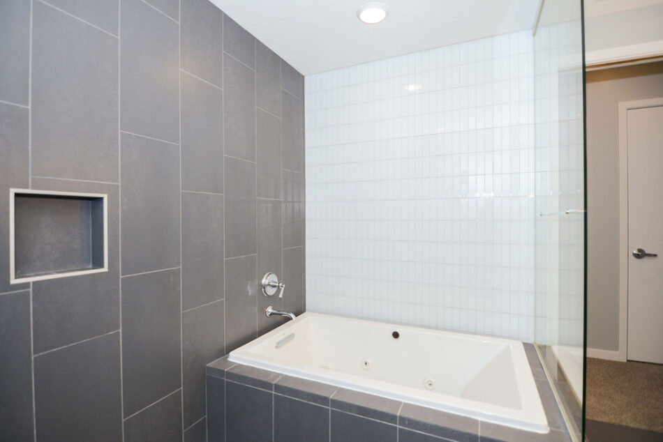 Shower with tiled tub.