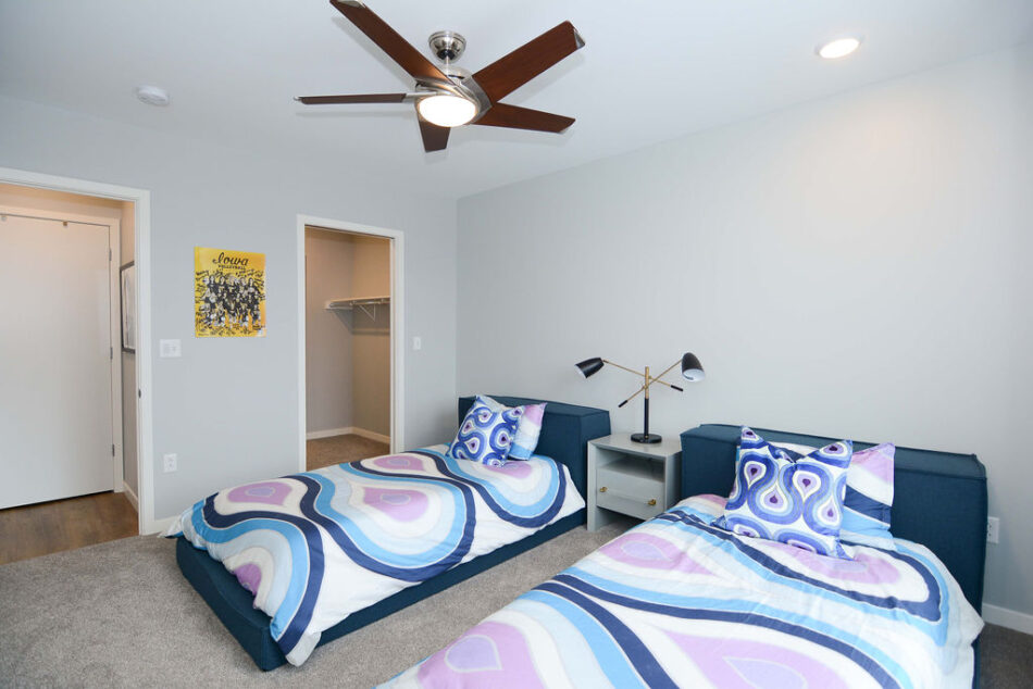 Bedroom with walk-in-closet and bathroom access.
