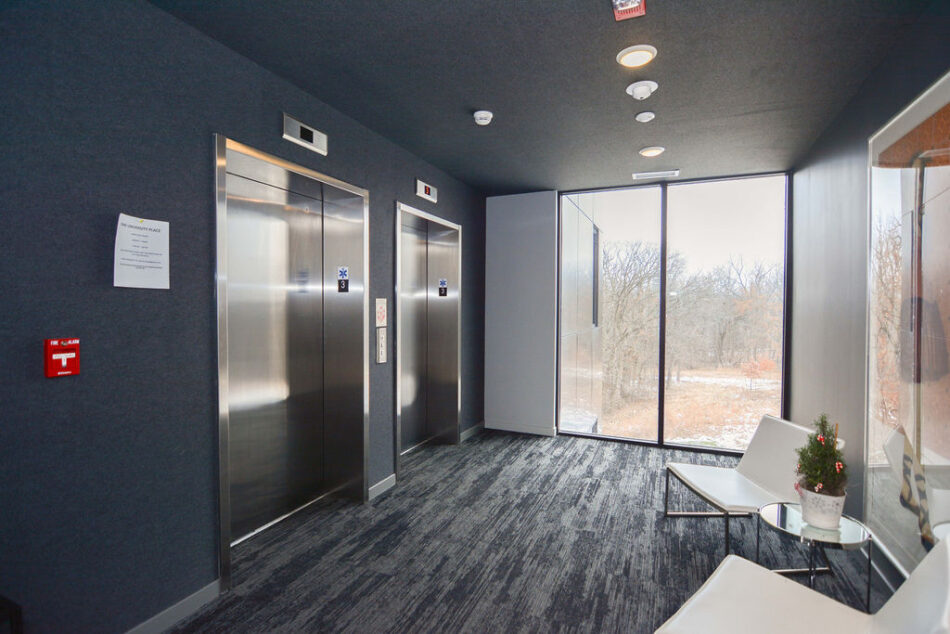 Elevators and sitting area outside condo.