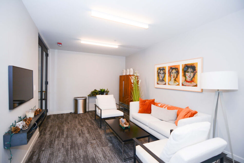 Sitting area and television in condo community area.