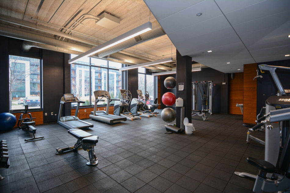 Private fitness center in condo with workout equipment.