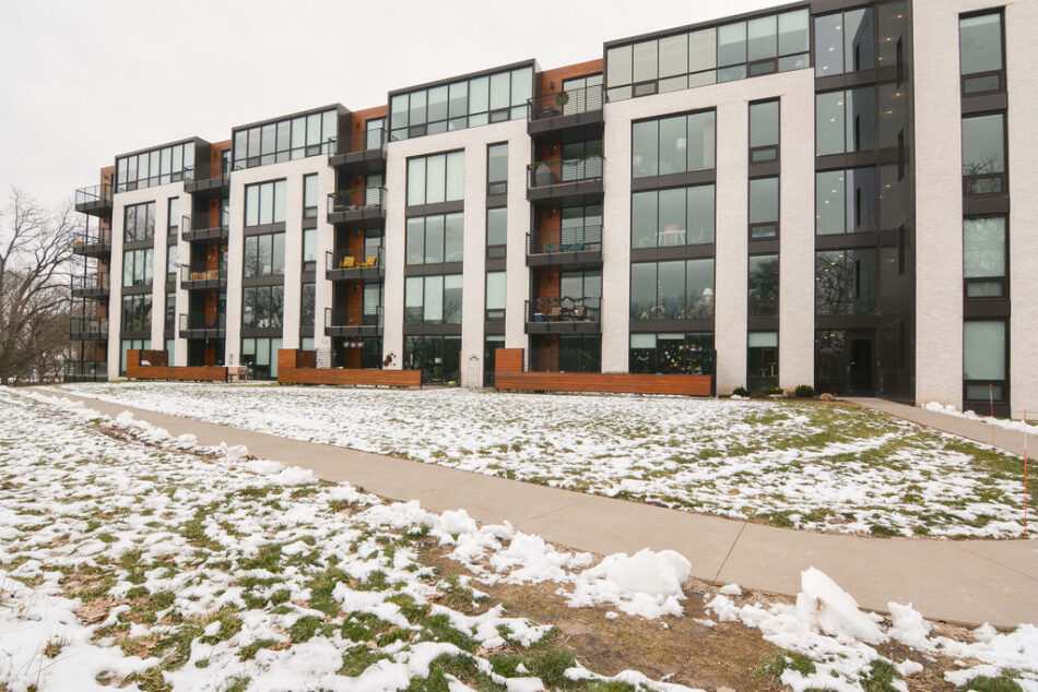 Back of condo building beyond paved walkway.