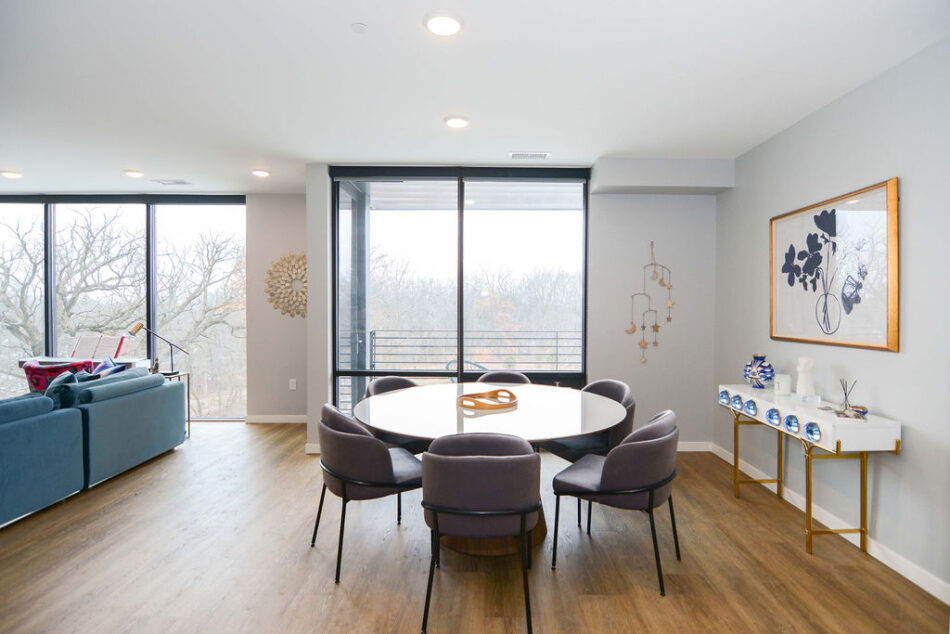 Dining area with floor-to-ceiling windows.