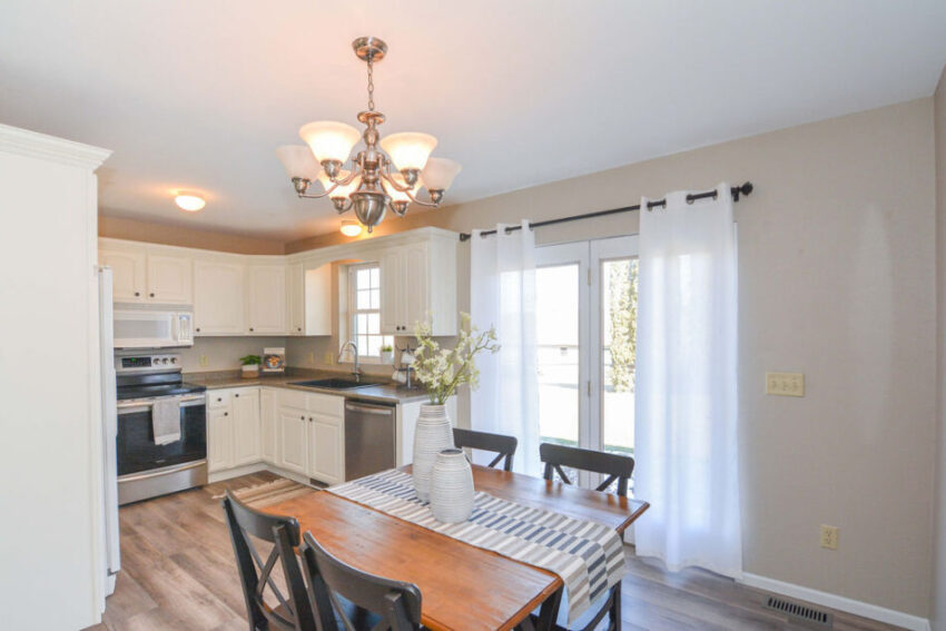 Dining area with beige walls and white molding.