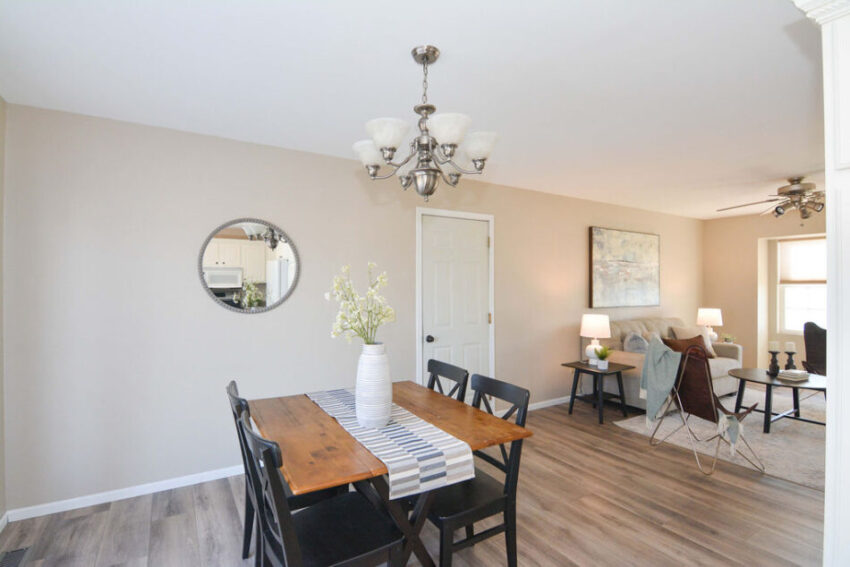 Dining area with chandelier over table.