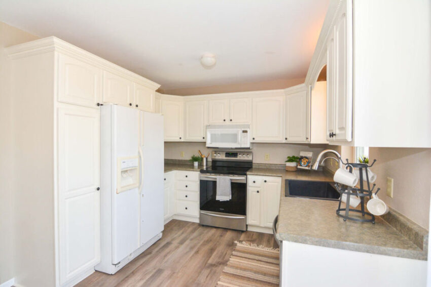 Kitchen white white cabinets and LVP floor.