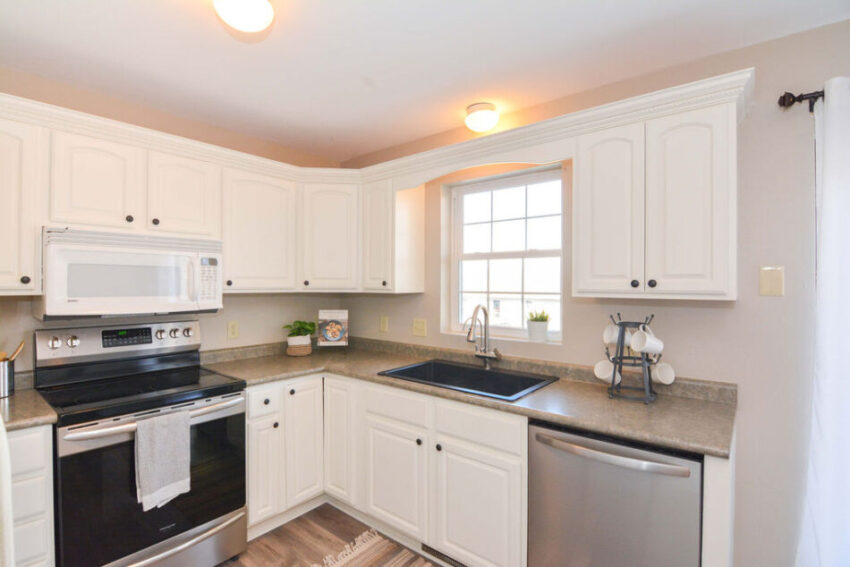 Kitchen with stainless steel dishwasher.