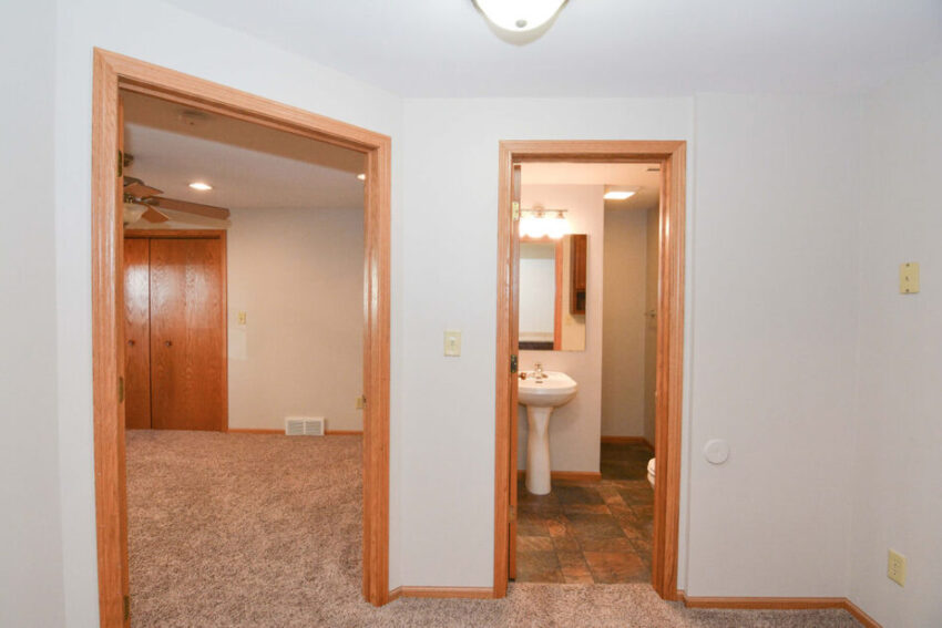 Hallway with entrances to bathroom and bedroom.