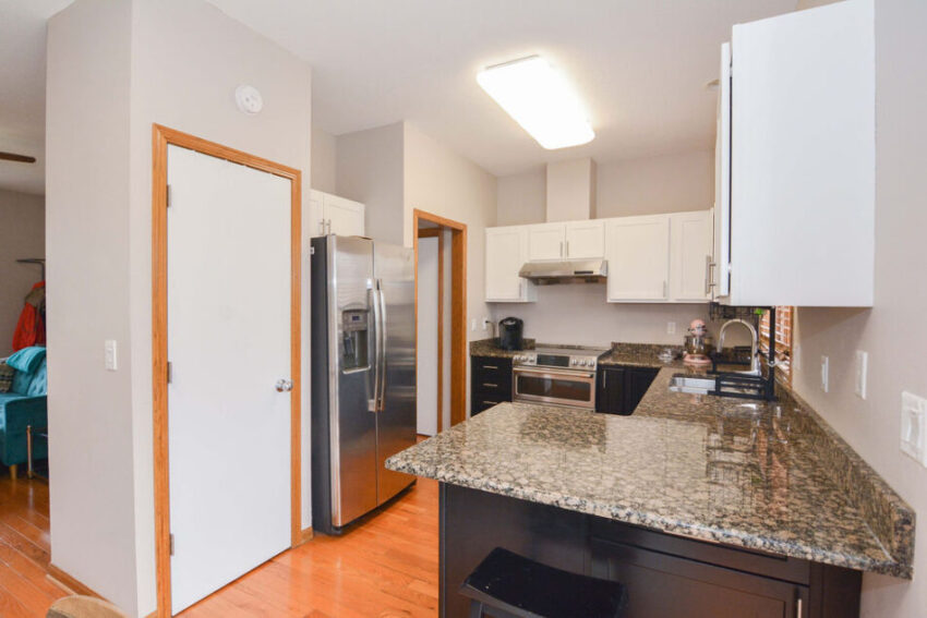 Kitchen with wrap-around granite counters.