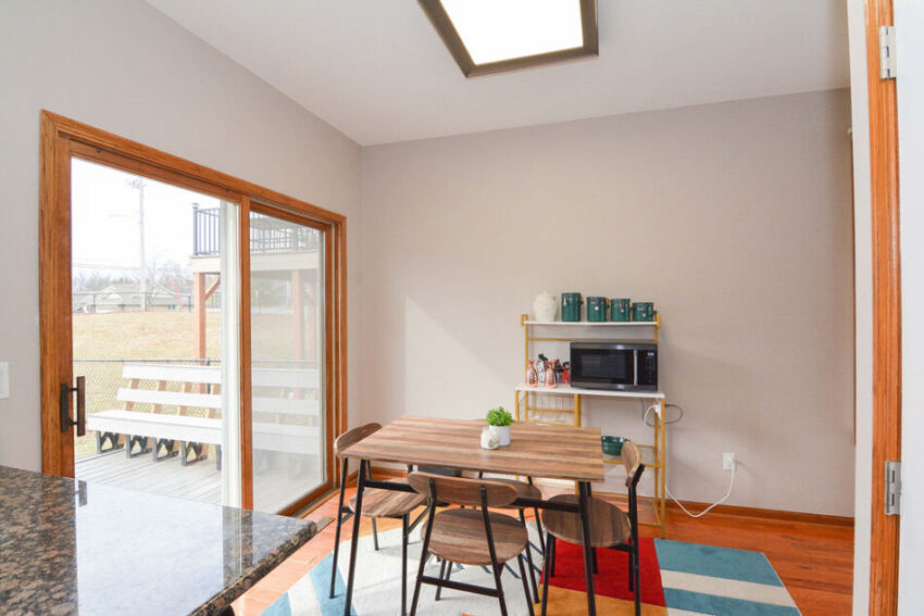 Dining area with sliding door with stoop beyond.