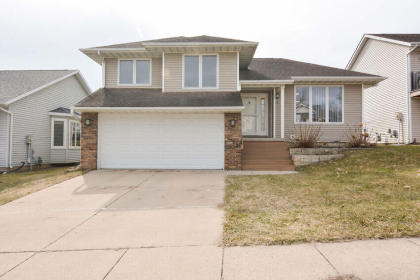 Exterior of multilevel home with two-car garage.