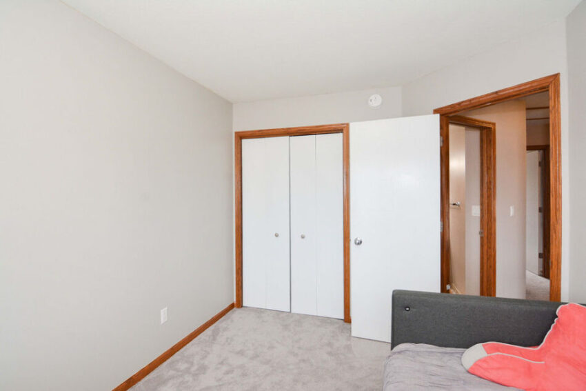 Bedroom with double closet doors.