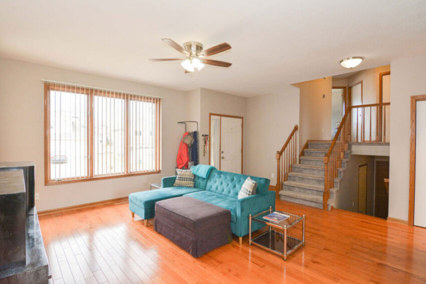 Living room in multi-level home with large windows.