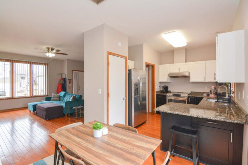 View from dining room with kitchen on one side and living room around corner.