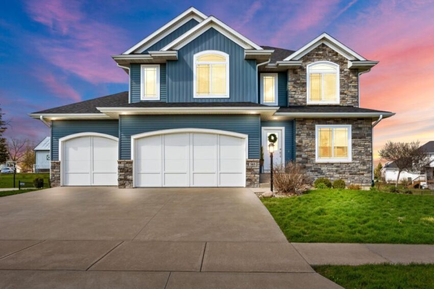 Gorgeous two story home with three heated garage stalls and glowing windows.