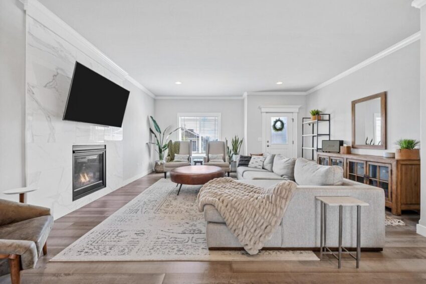 Living room with TV mounted above fireplace.