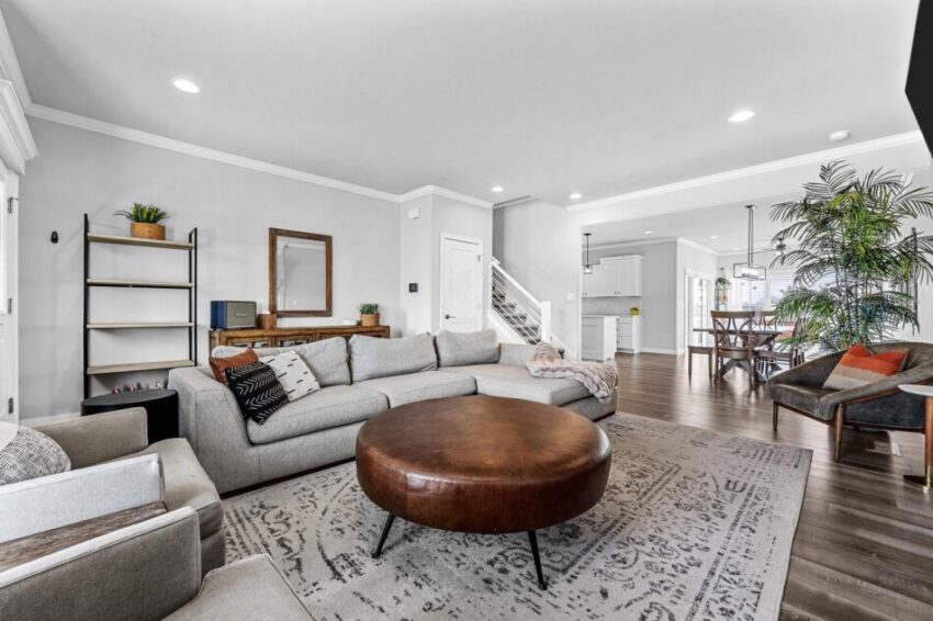 Beautiful living room with dining table and kitchen in the background.