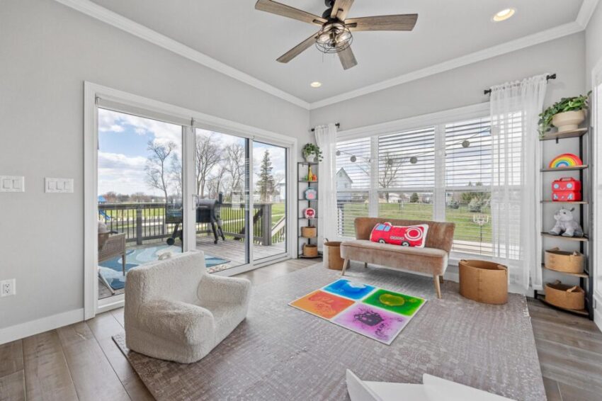 Cozy play area with access to deck with railing.