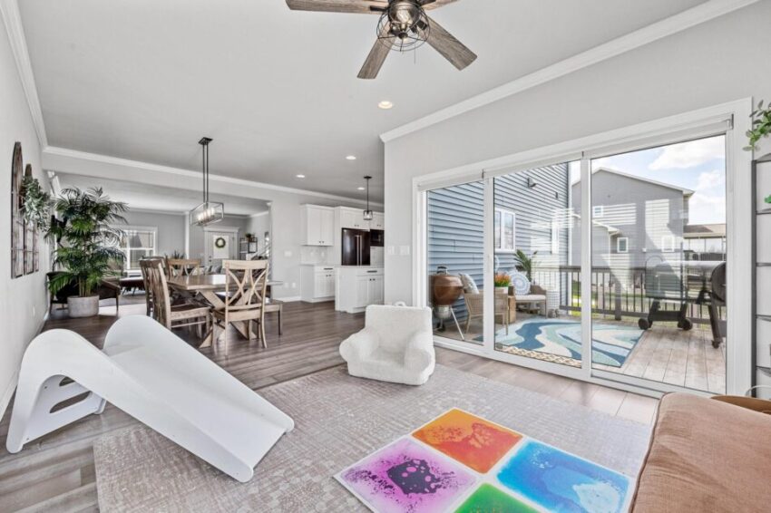 Children's hangout area with rug and small stuffed chair and slide.