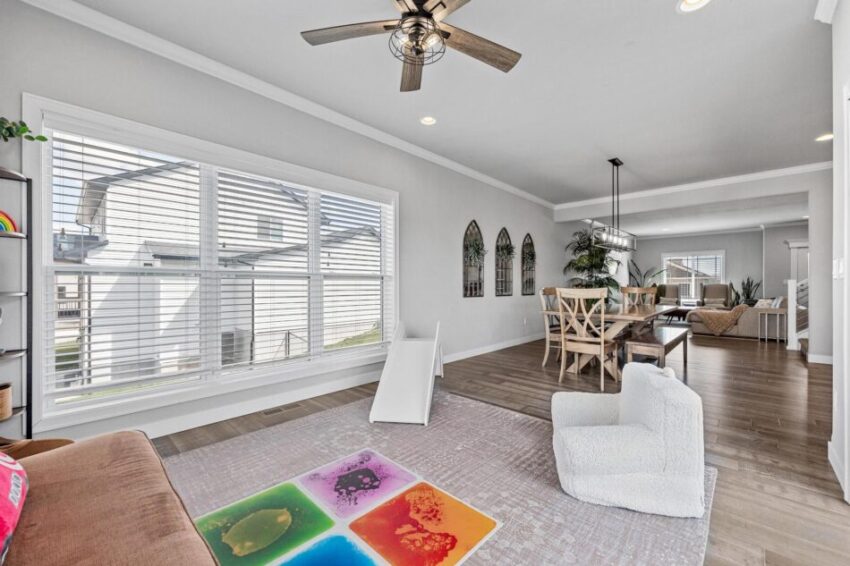 Play area for children off seamless main flow area of open-concept floorplan.