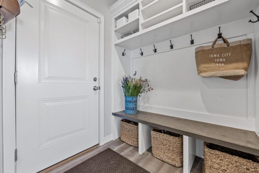 Mudroom with hooks and bench with baskets underneath.