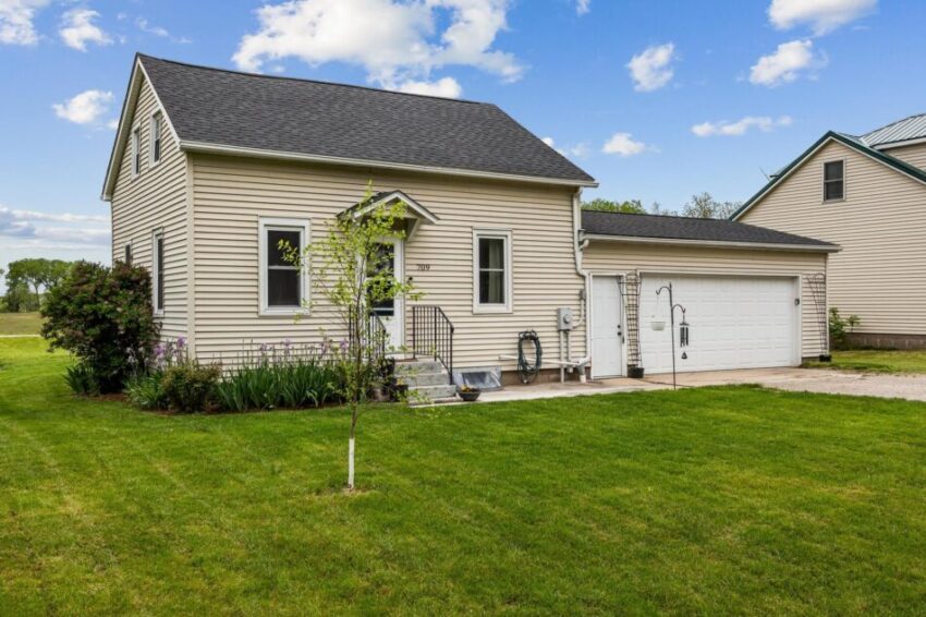 Cute home with stoop and wooden steps.