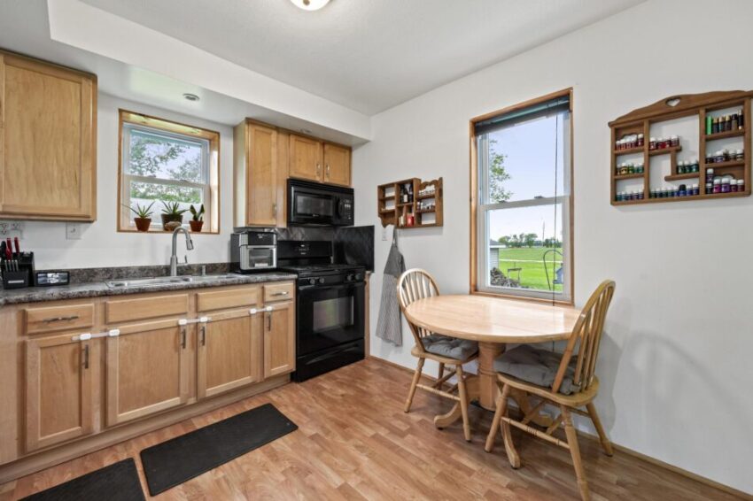 Kitchen with microwave, oven, and wooden cabinets.