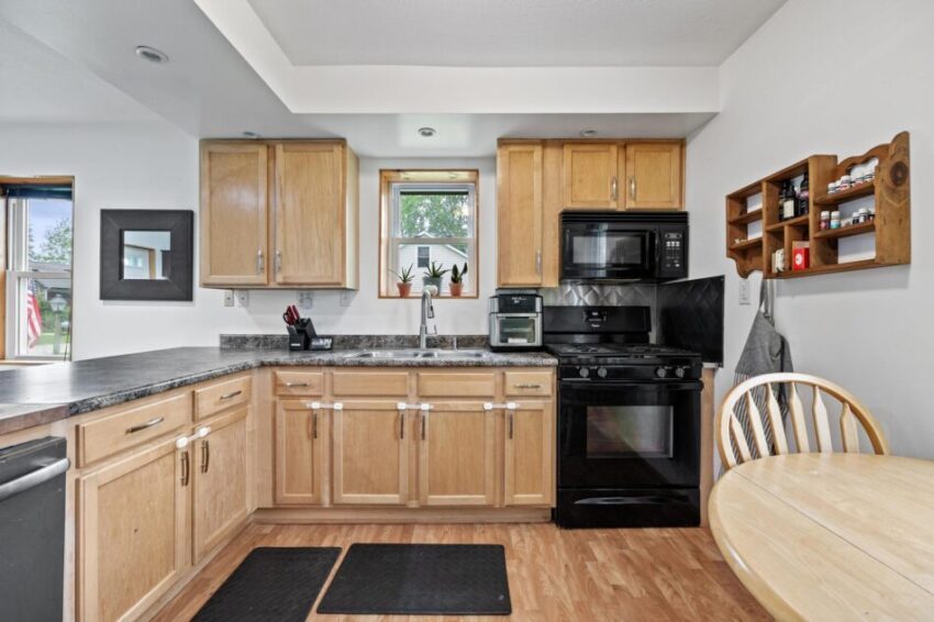 Kitchen with wooden cabinets and gray countertops.