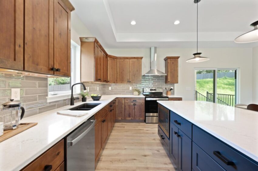 Kitchen with quartz countertops and navy blue island.