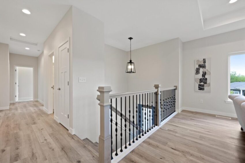 Landing with bannister and LVP flooring.