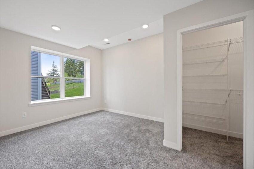 Bedroom with closet and beige walls.