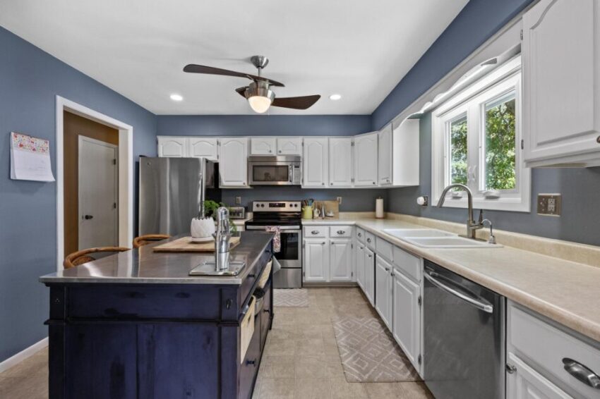 Kitchen with stainless appliances and functional island.
