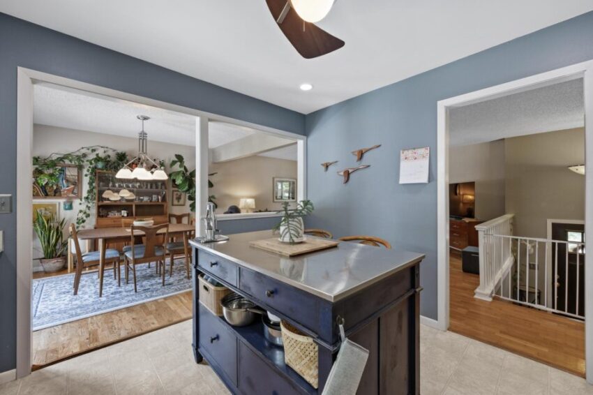 Kitchen island with stainless surface.