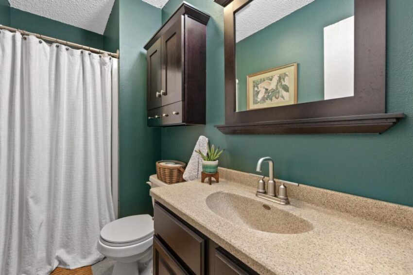 Bathroom with shower and large mirror.