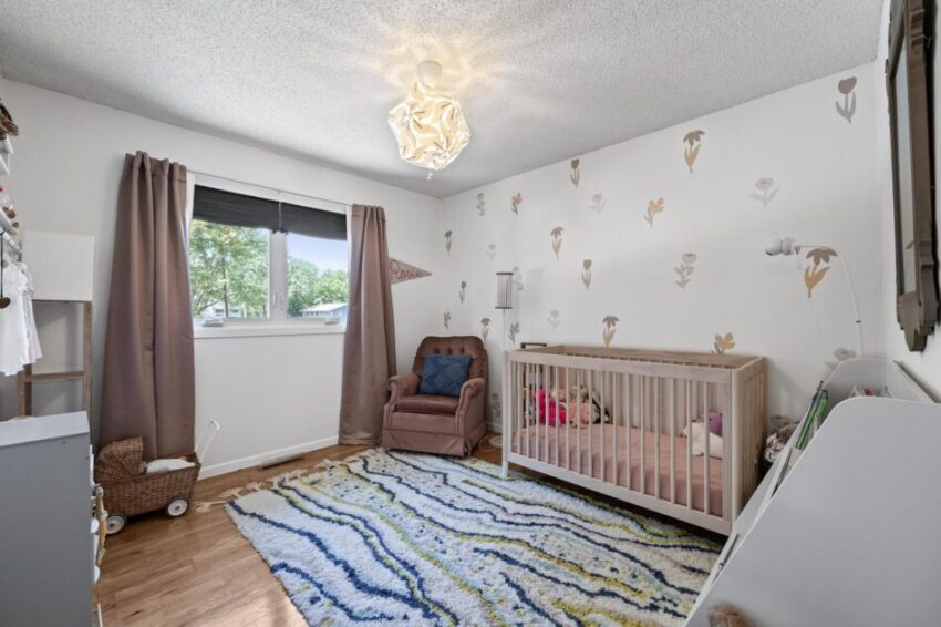 Child's bedroom with cute wallpaper.