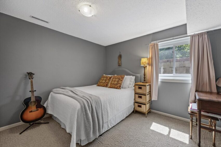 Bedroom with gray walls and carpet.