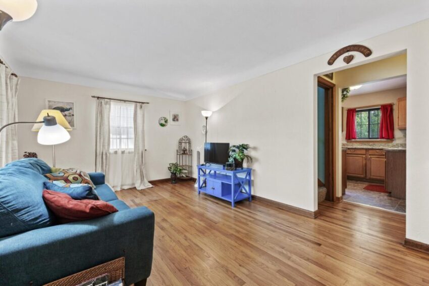 Living room with hardwood floors and wood trim.