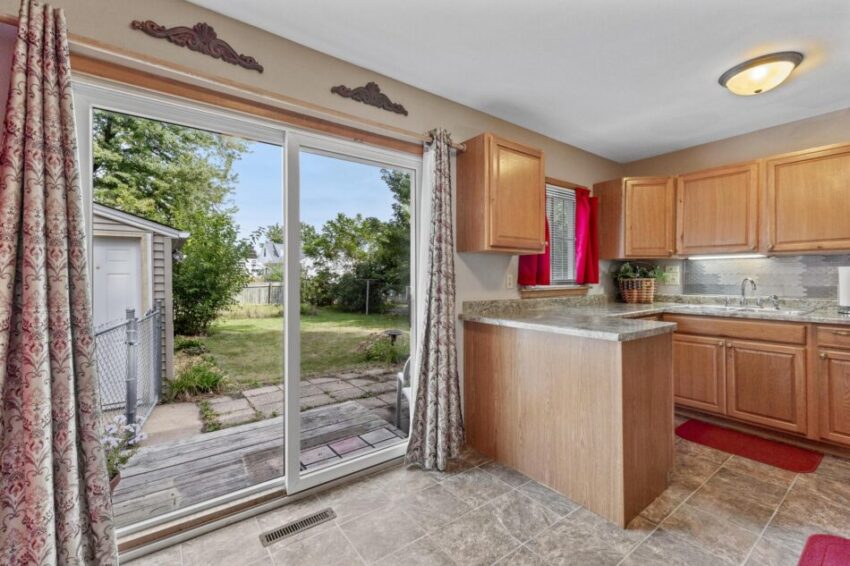 Updated kitchen with wood cabinets and wrap around counter.