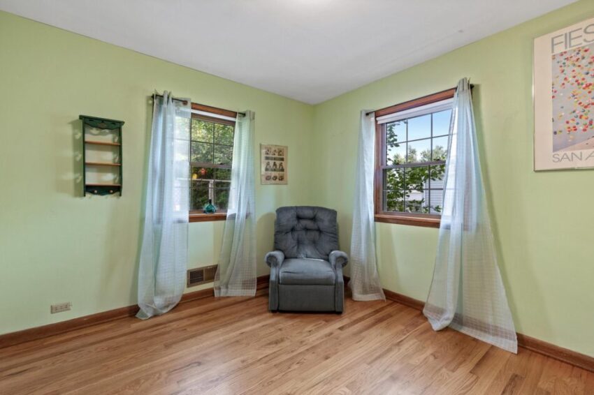 Bedroom 2, with lime walls, hardwood floor, and wood trim.