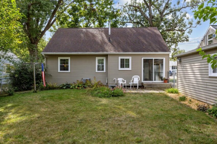 Backyard with garage on one side and sitting area.