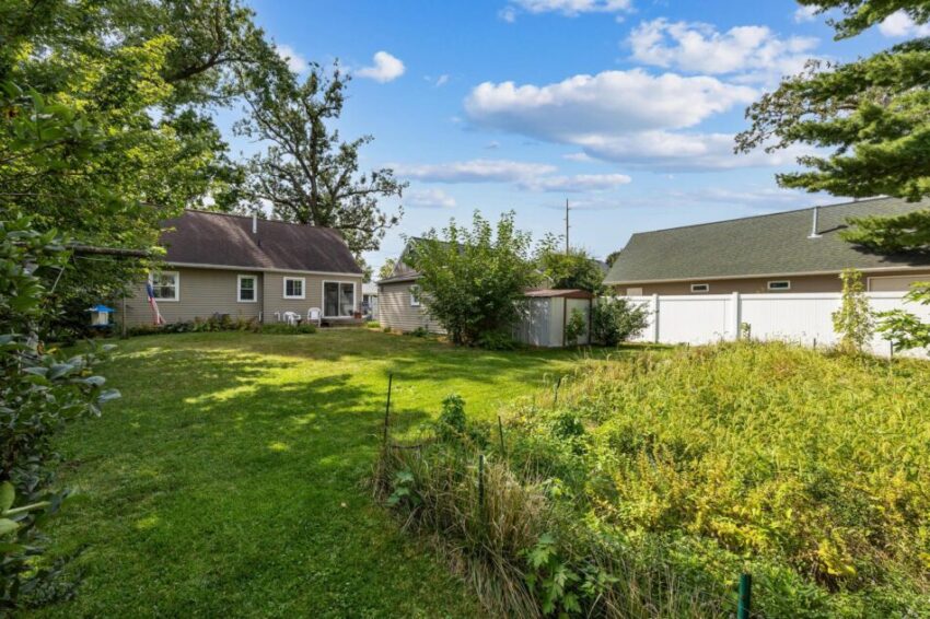 Backyard with garden and lawn.