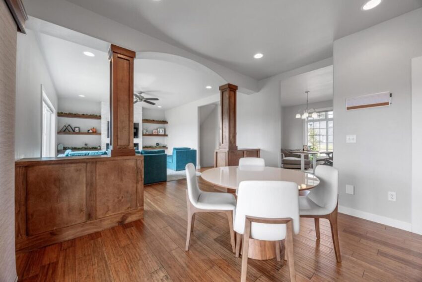 Dining room with custom woodwork, light gray walls, and white trim.