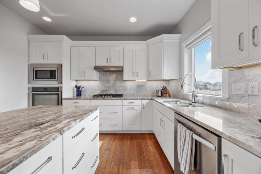 Kitchen with marble countertops and stainless steel appliances.
