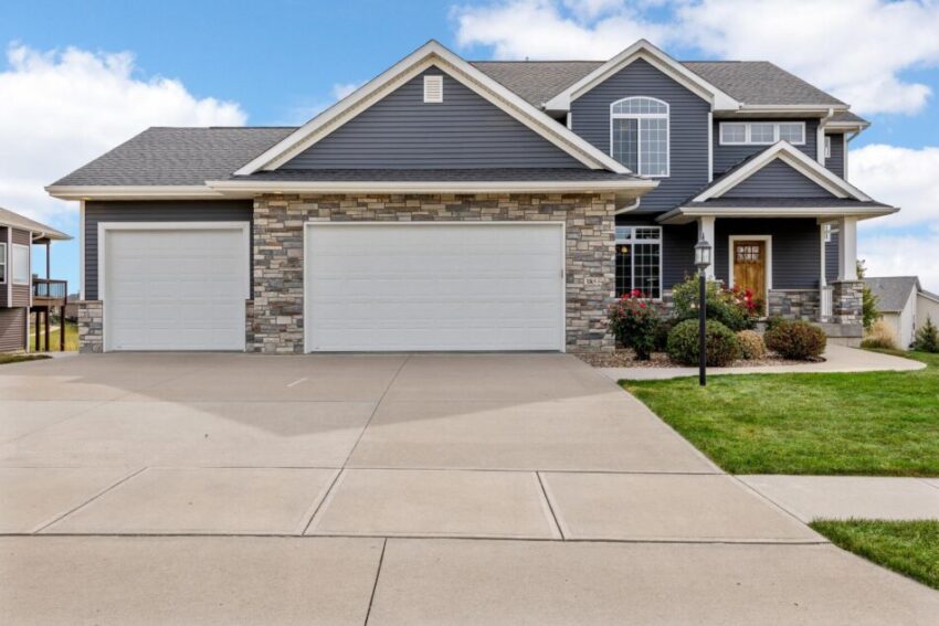 Two-story home with stone accents and two garage doors.