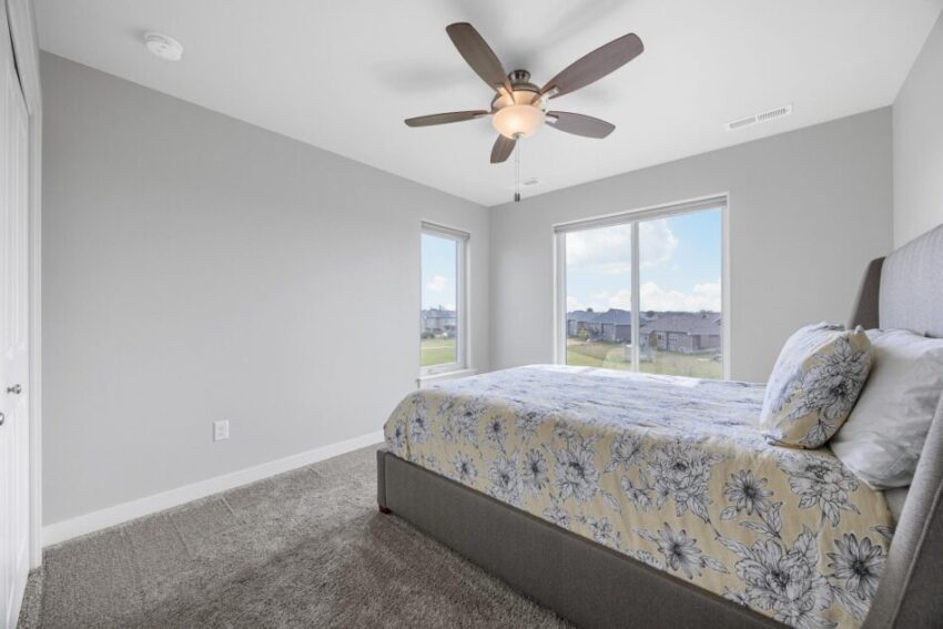 Bedroom 3, with ceiling fan, gray carpet, light walls, and white trim.