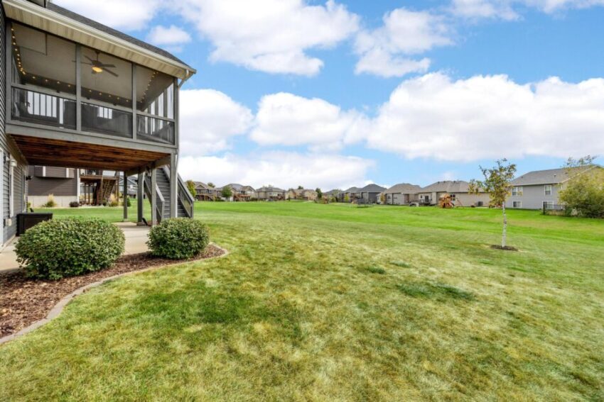 Expansive back lawn with view of neighborhood.