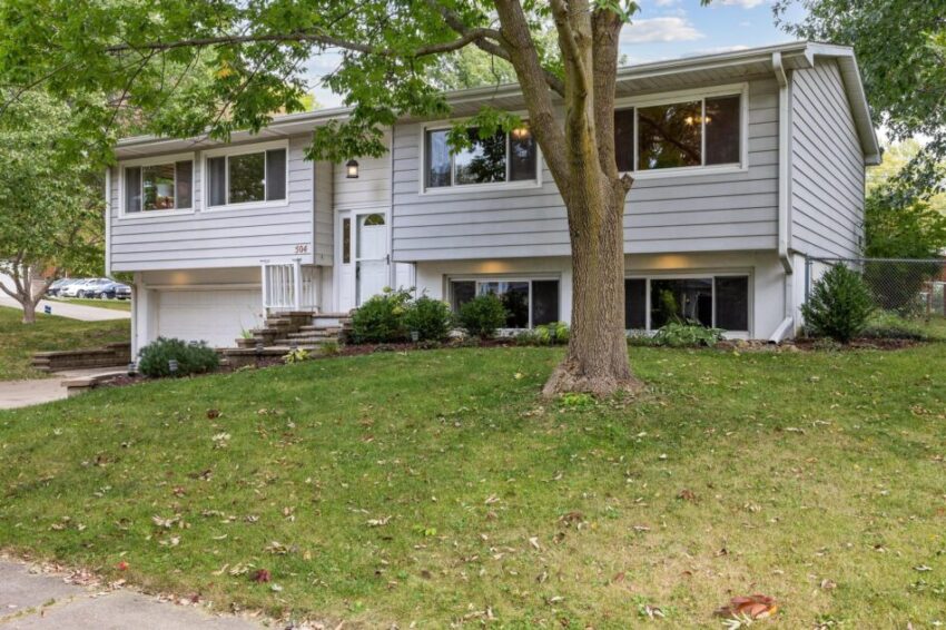 Front of split-level home with gray siding and white trim.