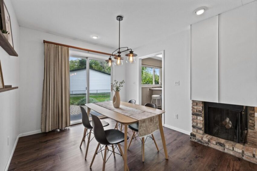Dining room with updated light fixture and LVP flooring.
