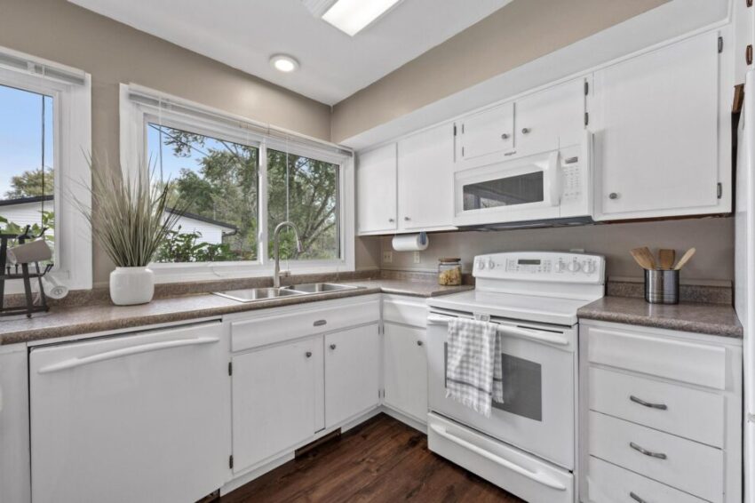 Kitchen with white oven, dishwasher, and microwave.